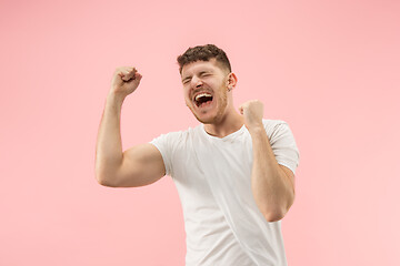 Image showing Winning success man happy ecstatic celebrating being a winner. Dynamic energetic image of male model