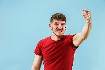 Image showing Young boy with a surprised expression bet slip on blue background