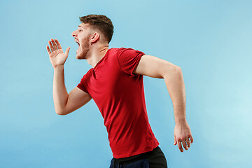 Image showing Isolated on pink young casual man shouting at studio