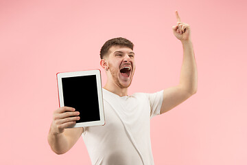 Image showing portrait of smiling man pointing at laptop with blank screen isolated on white