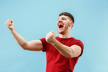 Image showing Winning success man happy ecstatic celebrating being a winner. Dynamic energetic image of male model