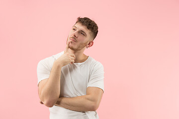 Image showing Young serious thoughtful businessman. Doubt concept.