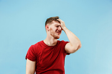 Image showing Young boy with a surprised expression bet slip on blue background