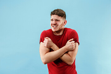 Image showing Young boy with a surprised expression bet slip on blue background