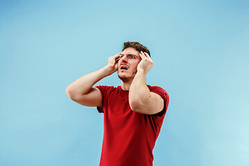 Image showing Young boy with a surprised expression bet slip on blue background