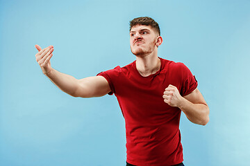 Image showing Young boy with a surprised expression bet slip on blue background