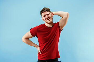 Image showing Man having headache. Isolated over blue background.