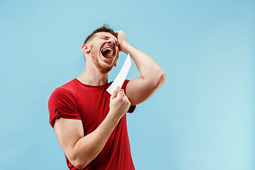 Image showing Young boy with a surprised expression bet slip on blue background