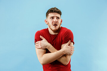 Image showing Young boy with a surprised expression bet slip on blue background