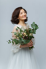 Image showing beautiful girl in white dress with big bouquet