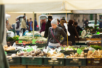 Image showing Woman buying vegetable at local food market. 