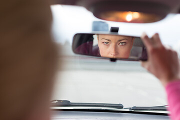 Image showing Lady looking back while reversing.