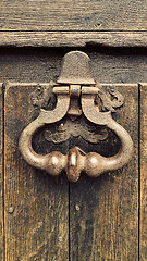 Image showing Vintage doorknocker on weathered wooden door background