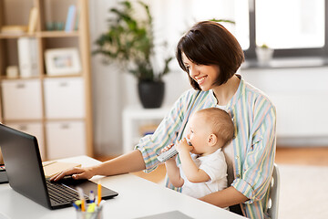 Image showing working mother with baby boy and laptop at home