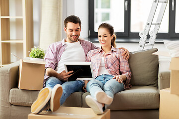 Image showing happy couple with boxes moving to new home