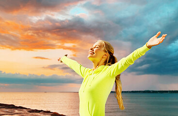 Image showing happy woman in sports clothes at seaside