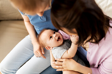 Image showing happy mixed-race family with baby son at home