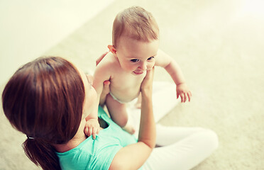 Image showing happy young mother with little baby at home