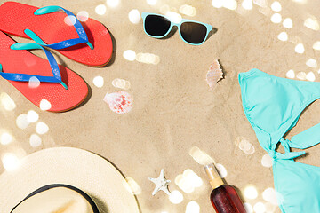 Image showing straw hat, flip flops and sunglasses on beach sand