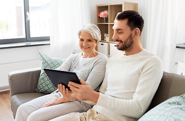 Image showing old mother and adult son with tablet pc at home