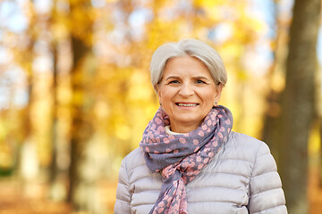 Image showing portrait of happy senior woman at autumn park