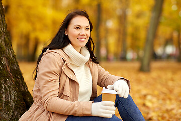 Image showing woman drinking takeaway coffee in autumn park