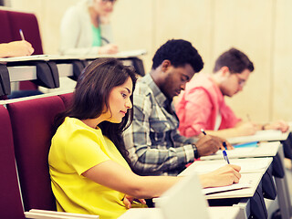 Image showing group of students with notebooks in lecture hall