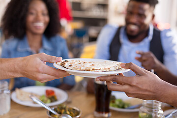 Image showing international friends eating at restaurant