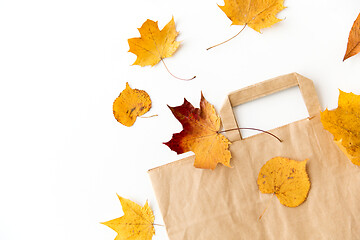 Image showing autumn leaves and paper bag on white background