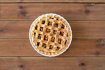 Image showing close up of apple pie in mold on wooden table