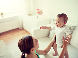 Image showing happy young mother with little baby at home