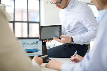 Image showing close up of business team with tablet pc at office