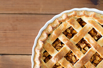 Image showing close up of apple pie in mold on wooden table