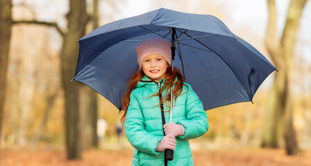 Image showing happy little girl with umbrella at autumn park