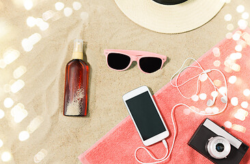 Image showing smartphone, camera, towel, hat and shades on beach