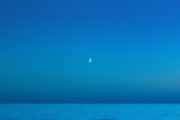 Image showing Blue Night Sky With A Crescent Moon Over The Sea