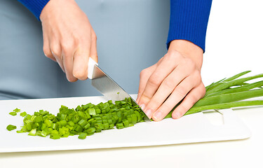 Image showing Cook is chopping green onion