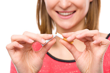 Image showing Young woman is breaking a cigarette