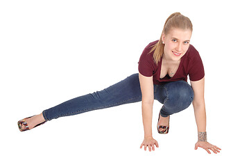 Image showing Slim young woman crouching on floor