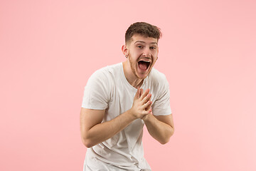 Image showing The happy business man standing and smiling against pink background.