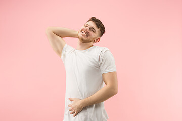 Image showing The happy businessman standing and smiling against pink background.