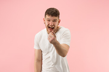 Image showing The happy business man standing and smiling against pink background.