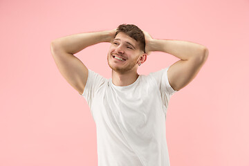 Image showing The happy businessman standing and smiling against pink background.