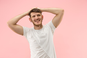 Image showing The happy businessman standing and smiling against pink background.