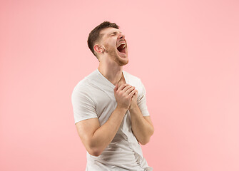 Image showing The happy business man standing and smiling against pink background.