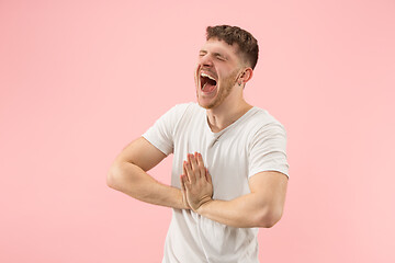 Image showing The happy business man standing and smiling against pink background.