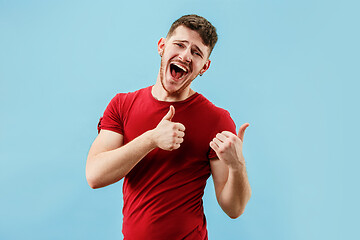 Image showing Isolated on pink young casual man shouting at studio