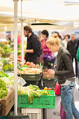 Image showing Woman buying vegetable at local food market.