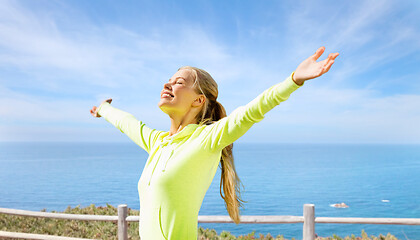 Image showing happy woman in sports clothes at seaside