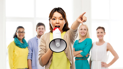 Image showing asian woman with megaphone over group of people